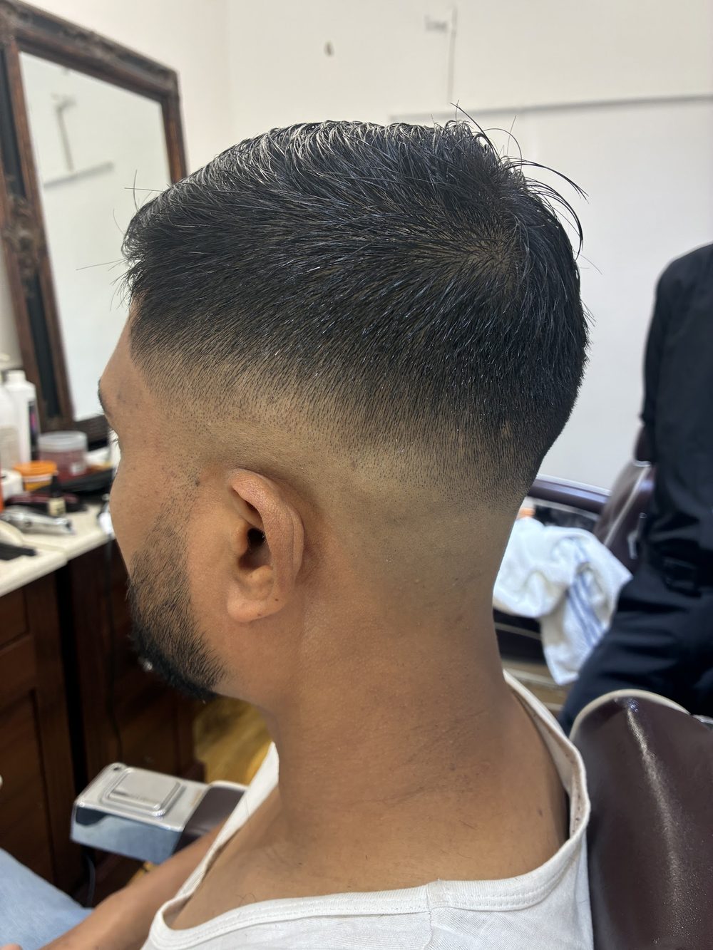 A crisp high fade blended into a textured crop, cut at Gentleman's Barber in Whitechapel.