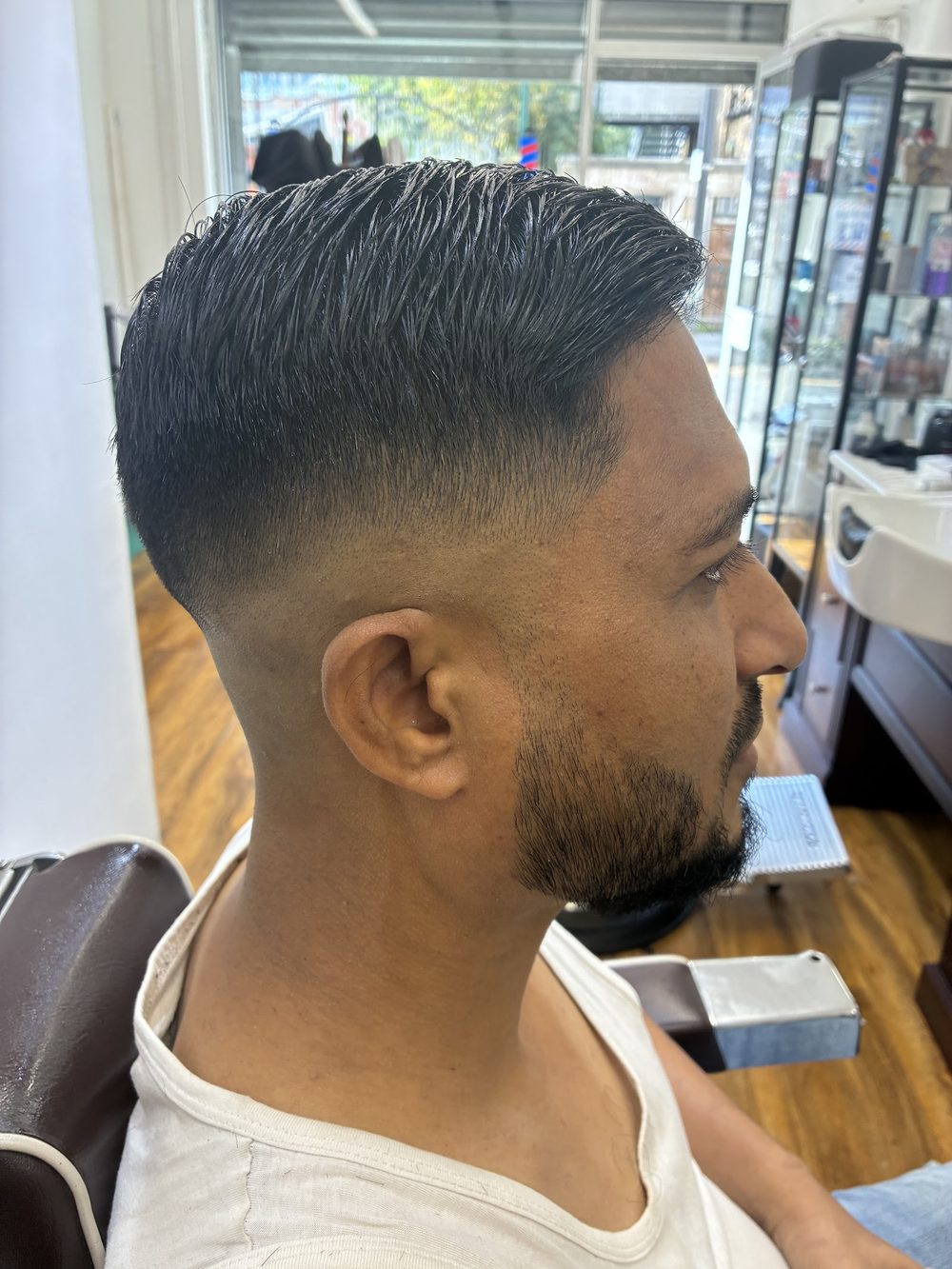 A sharp skin fade with a lined-up beard, finished at Gentleman's Barber.